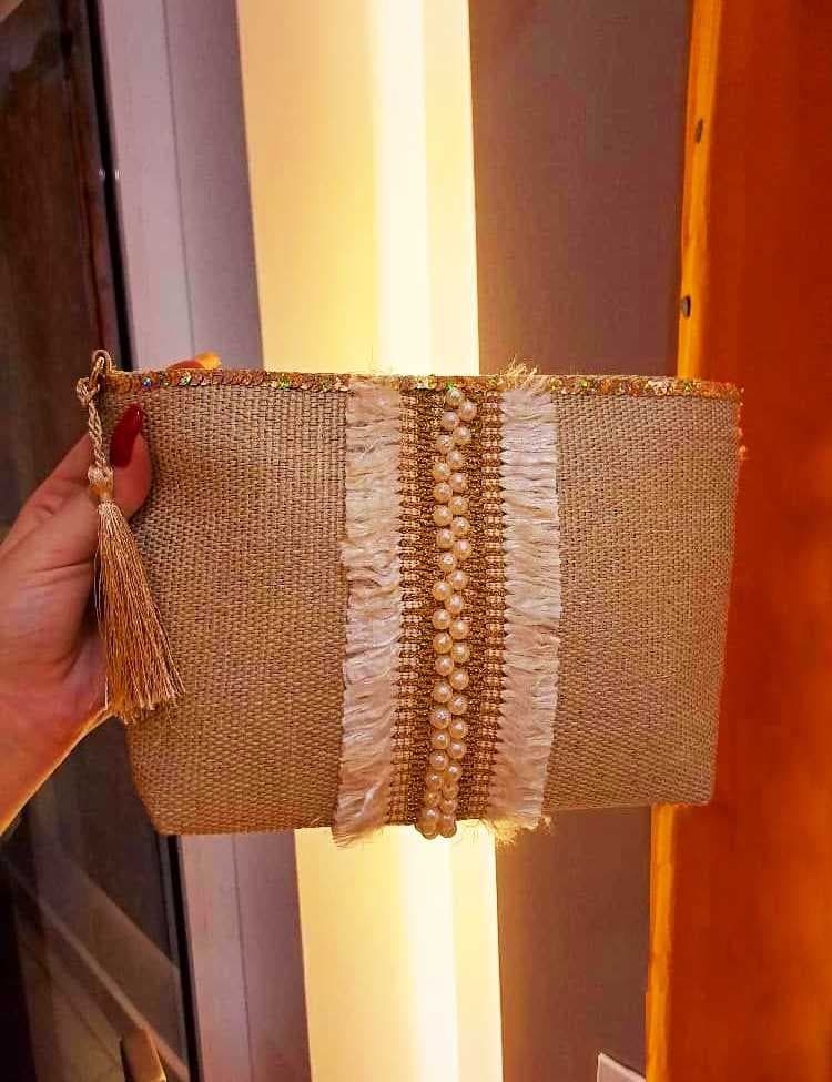 A chic clutch handbag crafted from natural jute