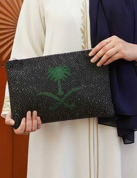 The clutch features a palm tree design black